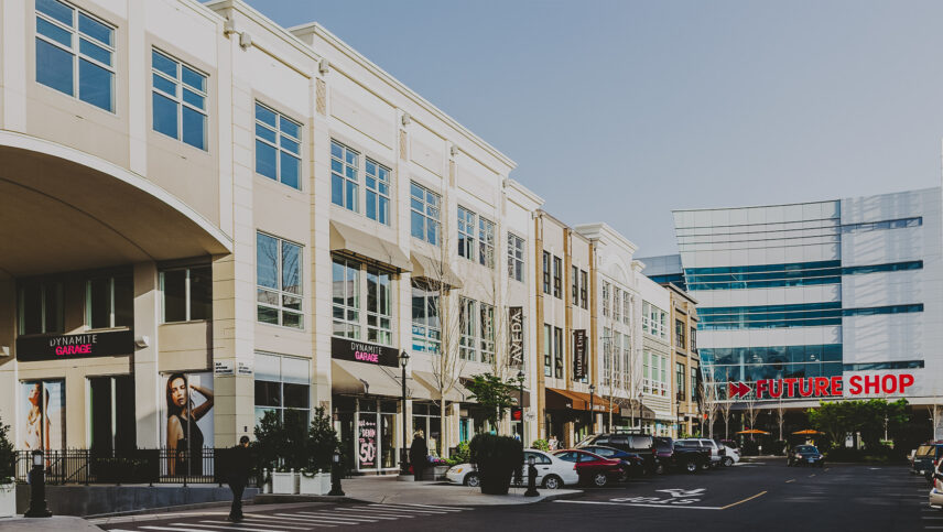 A vibrant retail and commercial complex in Saanich West, showcasing modern architecture with prominent stores and ample parking.