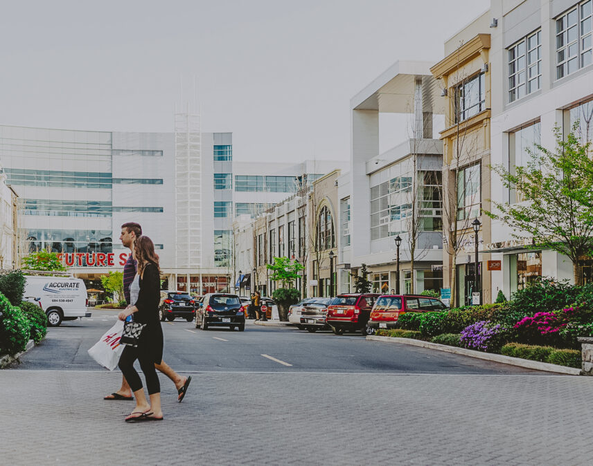 Saanich West neighborhood of Victoria, BC, featuring contemporary architecture, retail stores, and pedestrians crossing the street