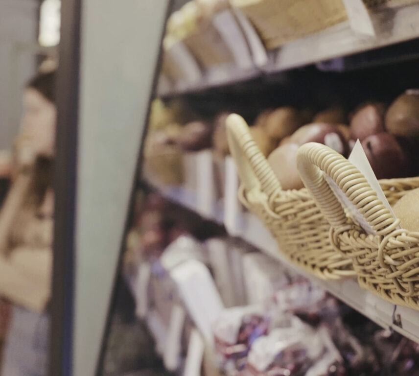 Close-up view of fresh produce displayed in wicker baskets on market shelves
