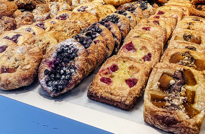 Assorted fruit and berry pastries displayed on a counter