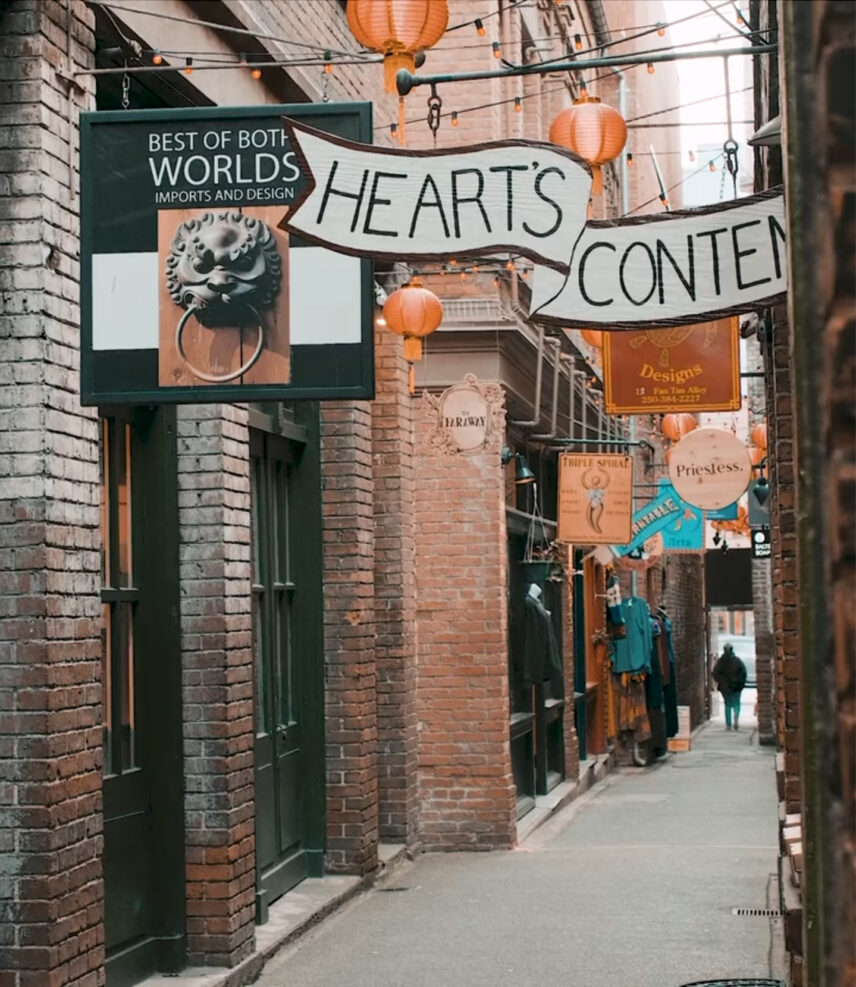 Narrow alleyway view of Fan Tan Alley in Victoria, BC, featuring unique boutique shops and lanterns