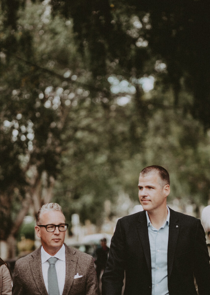 Two professional individuals Ole Schmidt and David Logan walking outdoors in a natural setting, representing Clover Residential