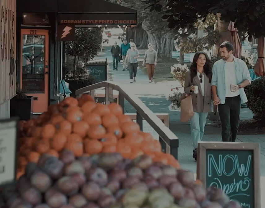 Couple walking by fresh produce at a local market in Victoria, BC