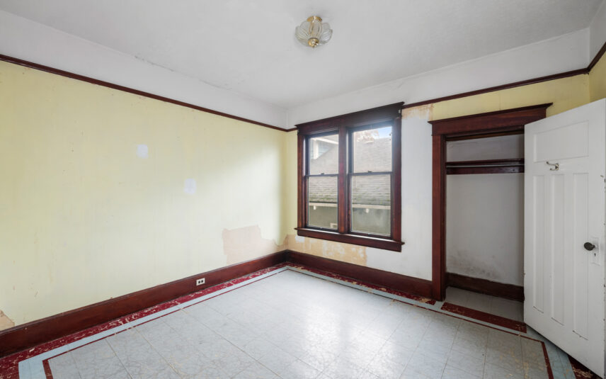 Bright bedroom at 624 Cornwall Street Victoria BC listed by Folio Group at Clover Residential featuring large windows wood trim and built-in closet in the Fairfield neighborhood