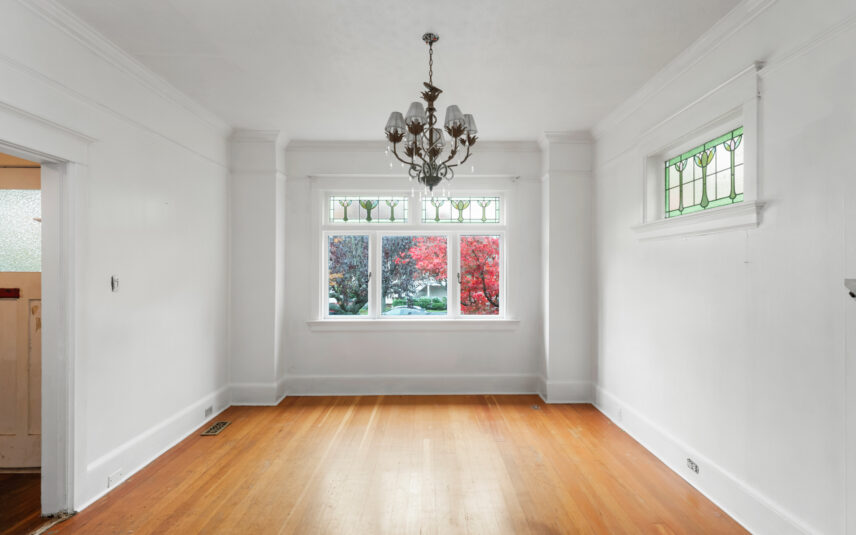 Bright dining room at 624 Cornwall Street Victoria BC listed by Folio Group at Clover Residential featuring stained glass windows a decorative chandelier and hardwood floors in the Fairfield neighborhood