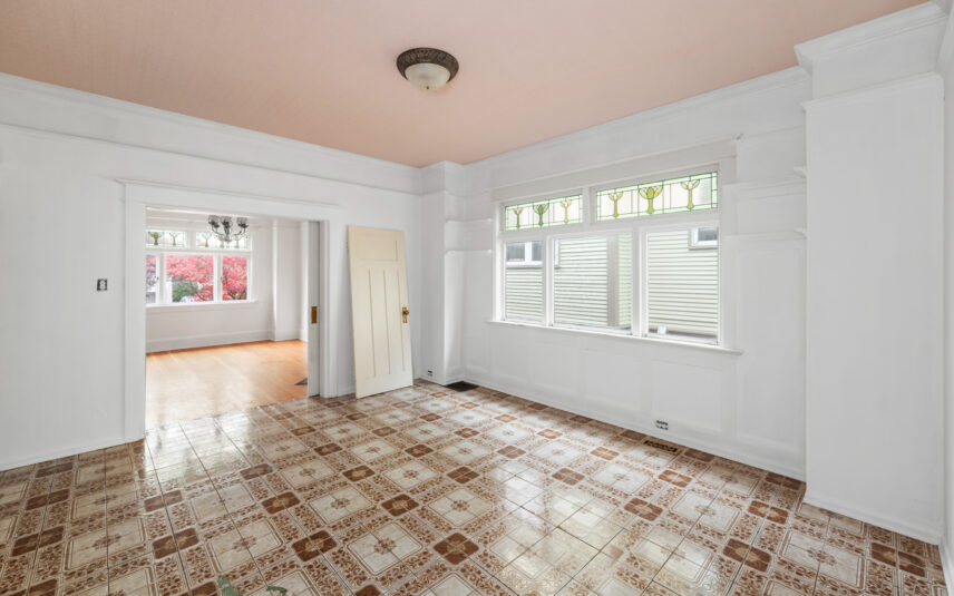 Bright living space at 624 Cornwall Street Victoria BC listed by Folio Group at Clover Residential featuring patterned tile flooring stained glass windows and an adjoining room with hardwood floors in the Fairfield neighborhood