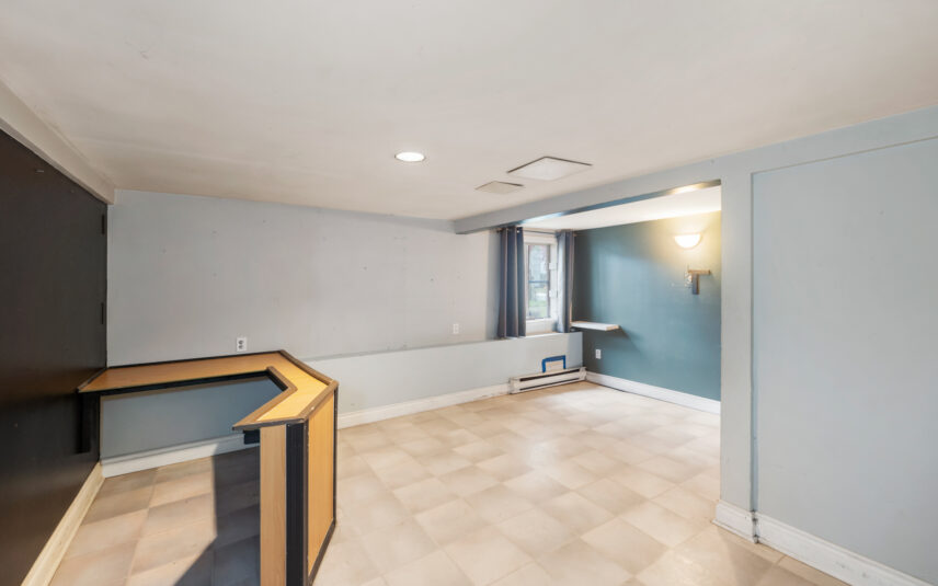 Lower-level room at 624 Cornwall Street Victoria BC listed by Folio Group at Clover Residential featuring tiled flooring a built-in desk and natural light from a large window in the Fairfield neighborhood