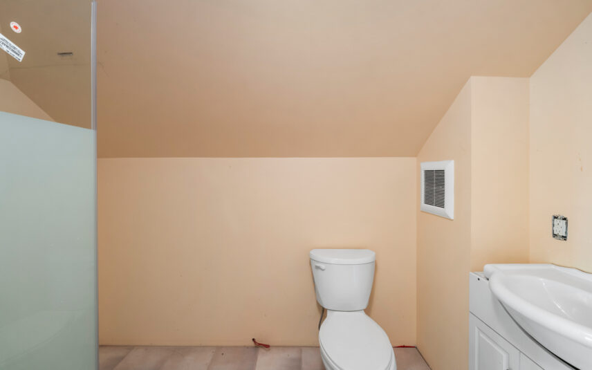 Compact bathroom at 624 Cornwall Street Victoria BC listed by Folio Group at Clover Residential featuring a sloped ceiling walk-in shower and modern fixtures in the Fairfield neighborhood