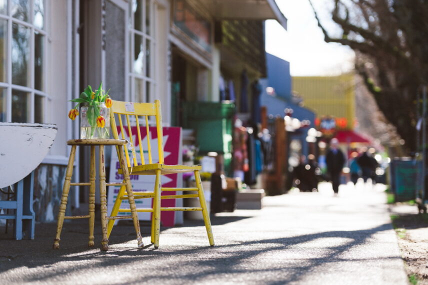 Yellow chair and table with tulips outside a charming storefront in the Fairfield neighborhood, 2250 Oak Bay Avenue