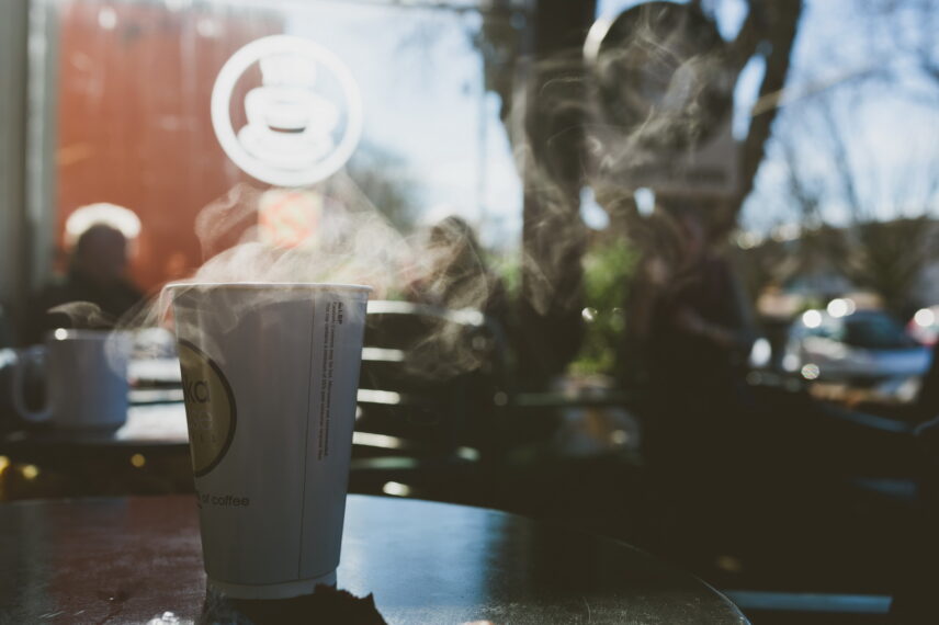 Steaming coffee cup on an outdoor café table in the Fairfield neighborhood, 2250 Oak Bay Avenue
