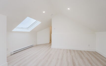 Attic room with vaulted ceilings, a skylight, light wood laminate flooring, and recessed lighting at 337 Robertson Street, managed by Clover Residential in Victoria, BC