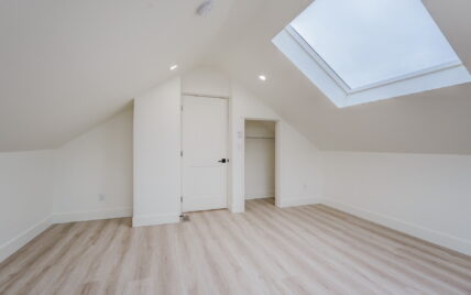 Attic bedroom with vaulted ceilings, a skylight, recessed lighting, a closet, and light wood laminate flooring at 337 Robertson Street, managed by Clover Residential in Victoria, BC